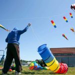 David Ngle works to attach another kite at Boxcar Park in Everett in 2020. Tuesday could see the first 67 degree day in the Everett area. (Kevin Clark / The Herald)