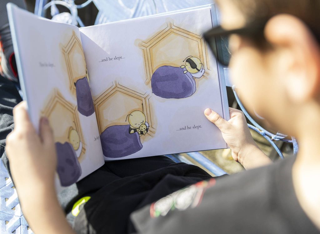 Oliver Popa shows one of his favorite pages in his book on Tuesday, March 25, 2025 in Edmonds, Washington. (Olivia Vanni / The Herald)