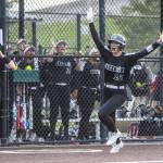 Jackson’s Allie Thomsen puts her arms up in celebration as she runs into home to score during the 4A district championship against Kamiak on Friday, May 17, 2024 in Everett, Washington. (Olivia Vanni / The Herald)