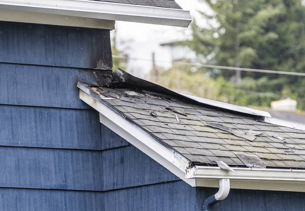 Black char marks and blown off shingles surround the area where lighting struck the Nichols home on Thursday, March 27, 2025 in Everett, Washington. (Olivia Vanni / The Herald)