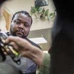 Barber student John Wrice watches instructor Don Sharretts technique as he trims a walk-in customers hair on March 14 at AHC Barber & Beauty College in Everett. (Olivia Vanni / The Herald)