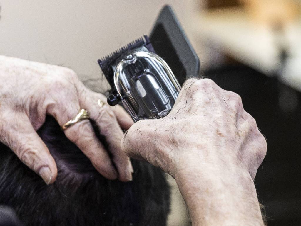 Small bits of hair cover Don Sharretts hand. (Olivia Vanni / The Herald)