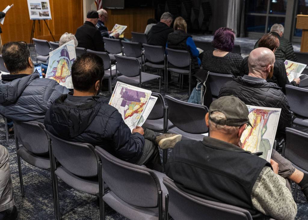 People look over zoning district map drafts of Everett available to the public during an Everett Planning Department open house at Everett Station on Wednesday, Feb. 26, 2025 in Everett, Washington. (Olivia Vanni / The Herald)