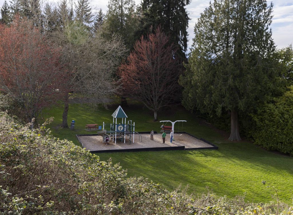 Children use the play structure at Hummingbird Hill Park late in the afternoon on Monday, March 31, 2025, in Edmonds, Washington. (Olivia Vanni / The Herald)