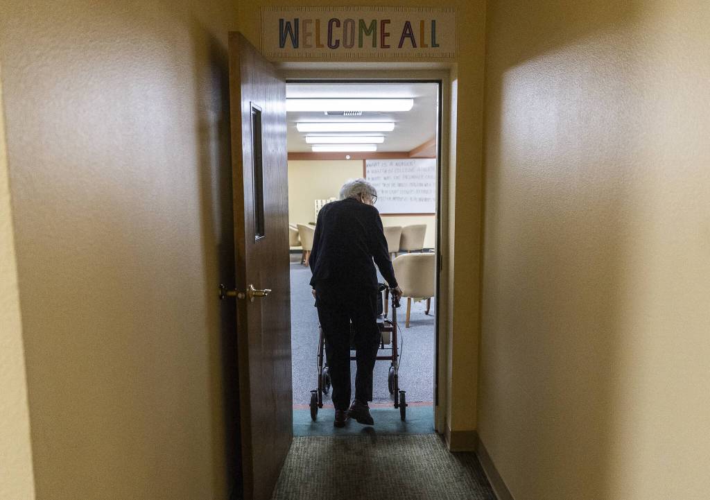 Mary Ann Karber walks into the game room at Washington Oakes in Everett. (Olivia Vanni / The Herald)