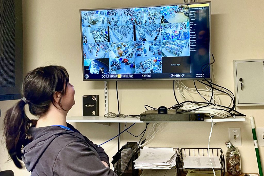 Jordan Hoffman-Nelson watches the store cameras Friday at Bellas Voice Thrift Store in Lynnwood. She watches for a couple hours each day, often detecting five to 10 thefts in a single sitting. (Aspen Anderson / The Herald)