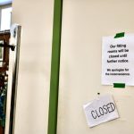A sign is taped to a fitting room door at Bellas Voice in Lynnwood, Washington. The fitting rooms a couple weeks ago after extensive shoplifting issues. (Aspen Anderson / The Herald)