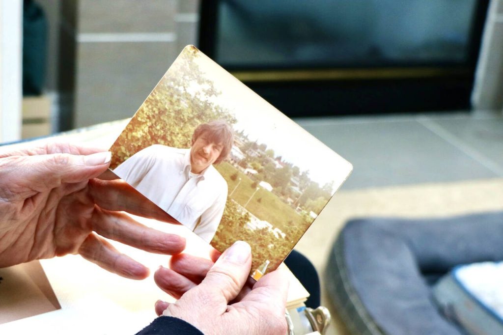 Wendy Banchero holds a photo of her late uncle, David DeDesrochers, at her home in Woodinville. (Aspen Anderson / The Herald)

