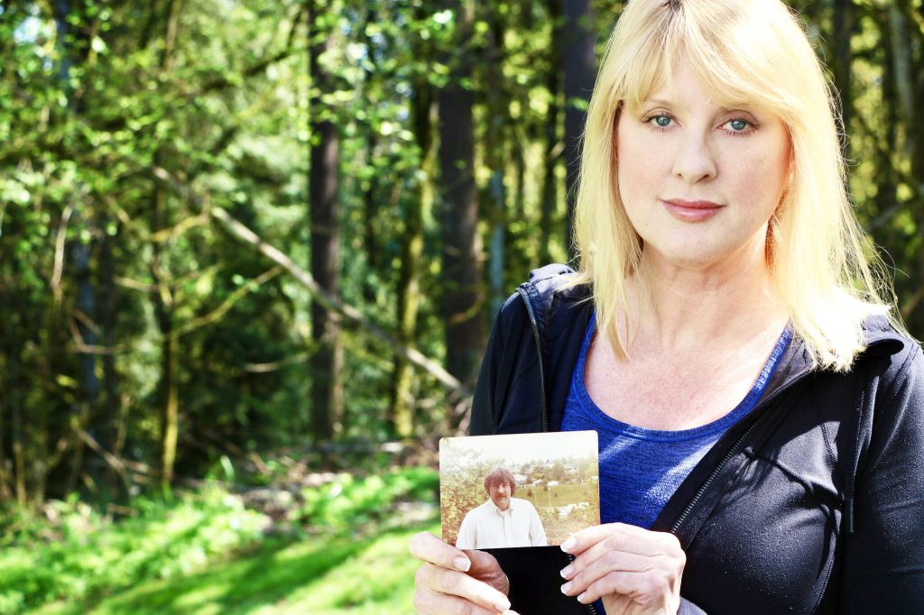 Aspen Anderson / The Herald
Wendy Banchero holds a photo of her late uncle, David DeDesrochers, outside her home in Woodinville.