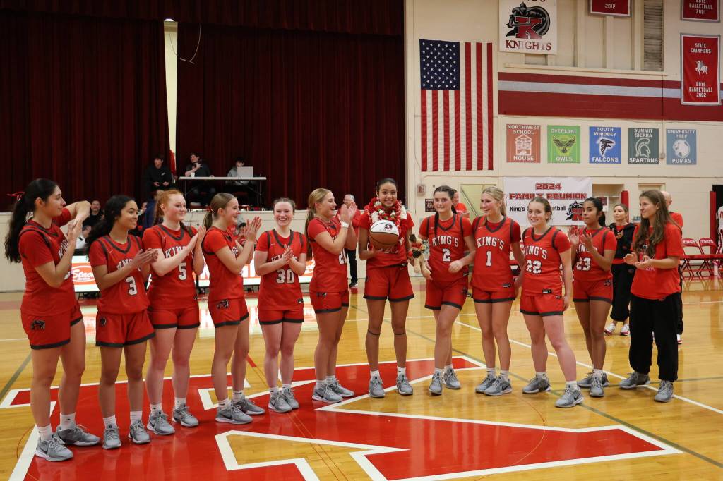 The King's girls basketball team gets ready to pose for a photo after a Jan. 31, 2025 game against Shorecrest in which Kaleo Anderson (10), sixth from the right, set the school's all time scoring mark at King's High School. (Courtesy of King's Athletics / Donna Beard)