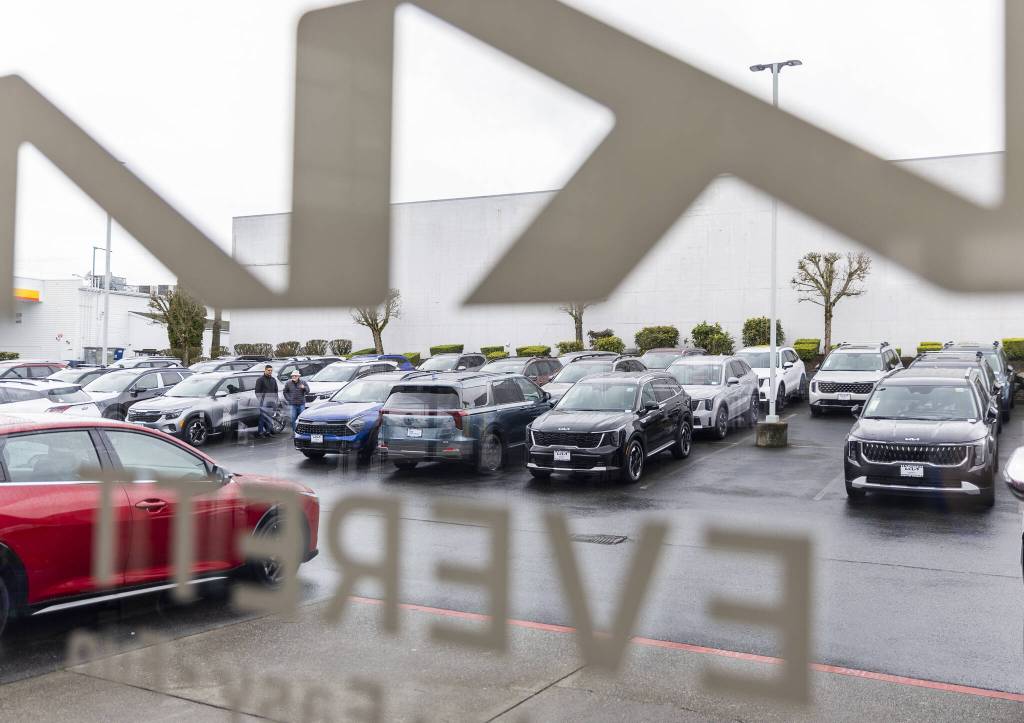 People browse cars for sale in the lot at Kia of Everett on Tuesday, April 1, 2025 in Everett, Washington. (Olivia Vanni / The Herald)