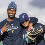 AquaSoxs Lazaro Montes and Milkar Perez smile and laugh for a photo during a break at practice at Funko Field on Tuesday, April 1, 2025 in Everett, Washington. (Olivia Vanni / The Herald)