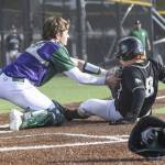 Edmonds-Woodways Trevelyan Podawiltz tags Jacksons Ashton Bergman as he slides into home for an out during the game on Wednesday, April 2, 2025 in Edmonds, Washington. (Olivia Vanni / The Herald)