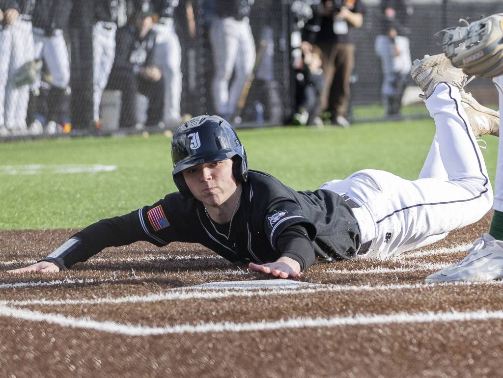 Jacksons MJ Holcomb slides into home to score during the game against Edmonds-Woodway on Wednesday, April 2, 2025 in Edmonds, Washington. (Olivia Vanni / The Herald)