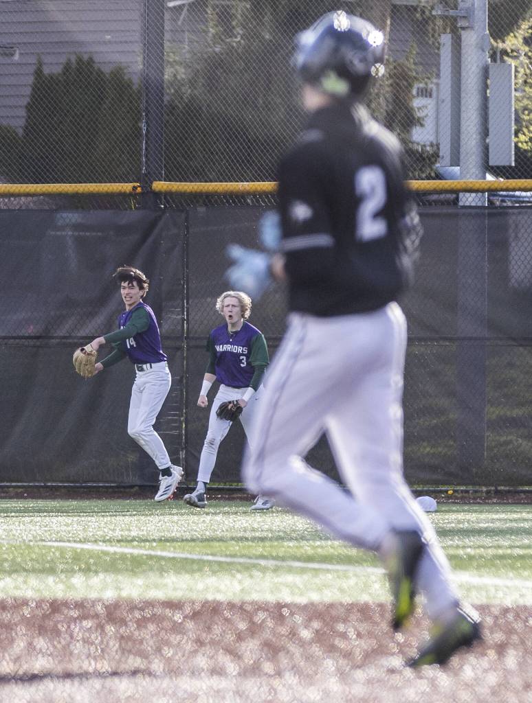 Edmonds-Woodways Toshi Gilginas makes a diving catch in the outfield and celebrates with teammate Lukas Wanke during the game against Jackson on Wednesday, April 2, 2025 in Edmonds, Washington. (Olivia Vanni / The Herald)