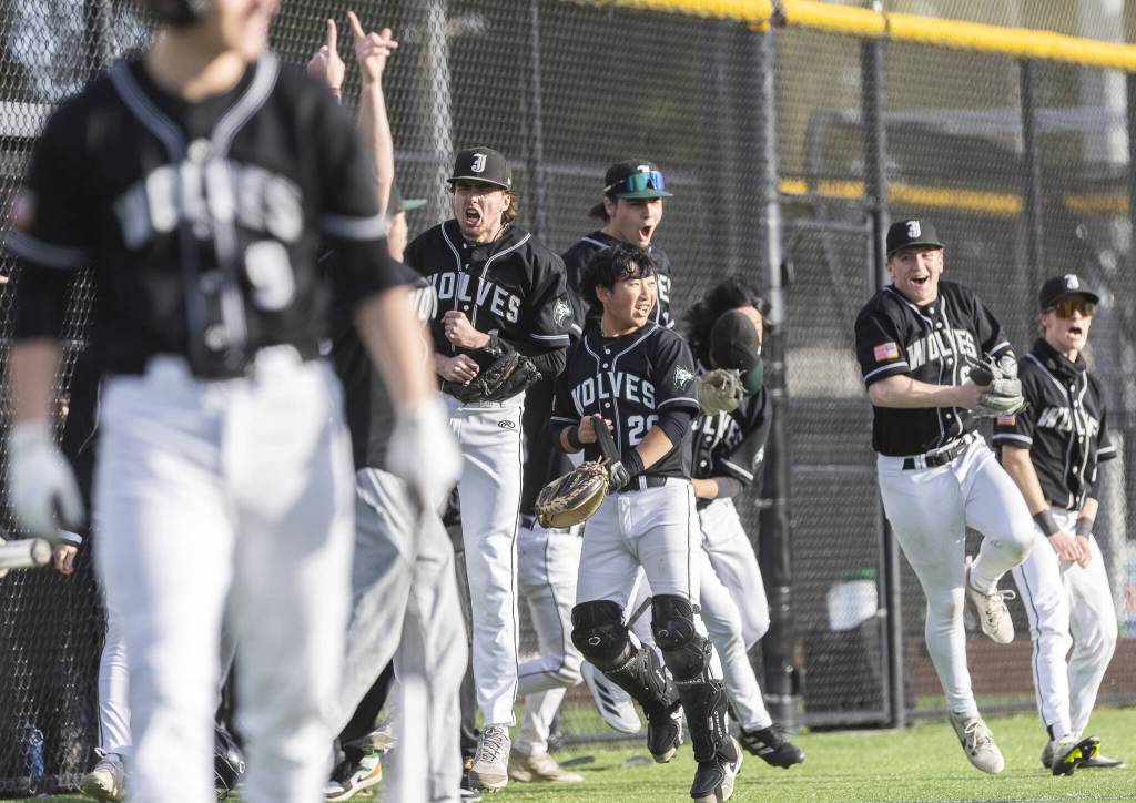 The Jackson dugout clears in celebration of their teammate Sam Craigs home run to put them ahead of Edmonds-Woodway during the game on Wednesday, April 2, 2025 in Edmonds, Washington. (Olivia Vanni / The Herald)