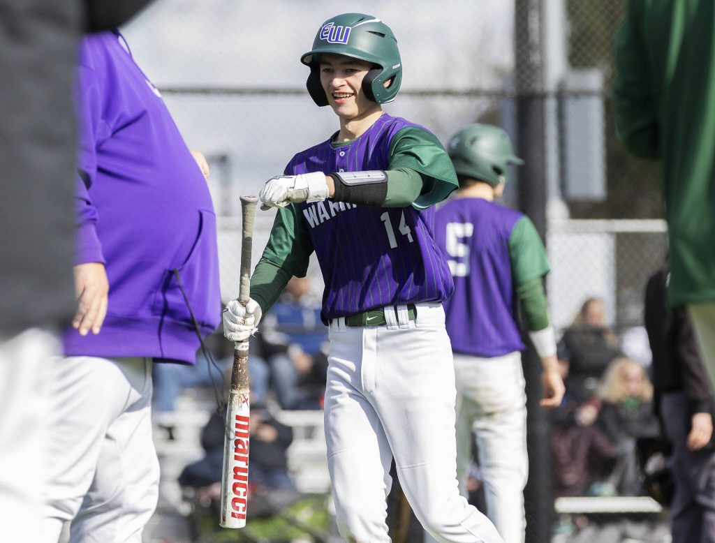 Edmonds-Woodways Toshi Gilginas smiles and fist bumps his coach after scoring during the game against Jackson on Wednesday, April 2, 2025 in Edmonds, Washington. (Olivia Vanni / The Herald)