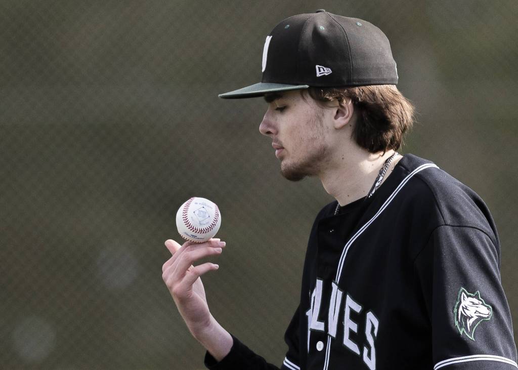Jacksons Drew Pepin balances the ball on his fingers while waiting for the the next batter during the game against Edmonds-Woodway on Wednesday, April 2, 2025 in Edmonds, Washington. (Olivia Vanni / The Herald)