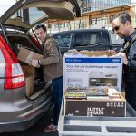 Bryson Fico, left, unloaded box of books from his car with the help of Custody Officer Jason Morton as a donation to the Marysville Jail on Saturday, April 5, 2025 in Marysville, Washington. (Olivia Vanni / The Herald)
