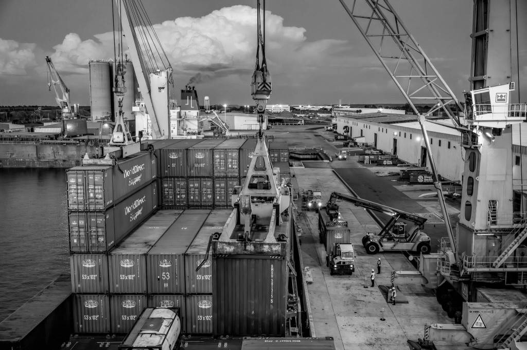 Scott McIntyre / The New York Times
Longshoremen offload containers from the Queen B at Port Manatee in Palmetto, Fla., April 1. Businesses that had ordered the cargo on the vessel were doing all they could to get their purchases through U.S. customs before Wednesday, to ensure that they would not have to pay the new, higher levies.