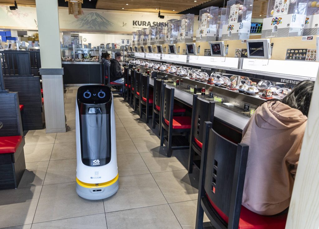 Kur-B, a delivery robot, returns after delivering drinks to a table at Kura Revolving Sushi Bar on Monday, April 7, 2025 in Lynnwood, Washington. (Olivia Vanni / The Herald)