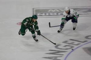 Everett Silvertips forward Nolan Chastko (19) skates towards a loose puck in the neutral zone while being pursued by Seattle Thunderbirds forward Nathan Pilling during Everett's 7-4 win in Game 5 of the WHL Playoffs First Round at Angel of the Winds Arena in Everett, Washington on April 5, 2025. (Joe Pohoryles / The Herald)