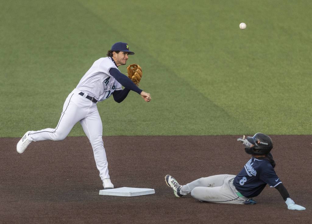Everett AquaSox second baseman Charlie Pagliarini gets an out at second and throws the ball to first during the Opening Day game against the Hillsboro Hops on Tuesday, April 8, 2025 in Everett, Washington. (Olivia Vanni / The Herald)