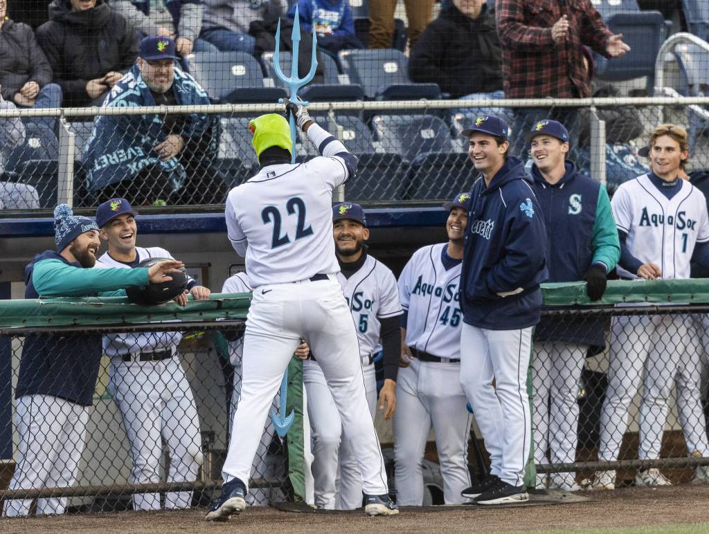 Everett AquaSox outfielder Lazaro Montes celebrates his home run in a frog mask while hoisting a trident during the Opening Day game against the Hillsboro Hops on Tuesday, April 8, 2025 in Everett, Washington. (Olivia Vanni / The Herald)