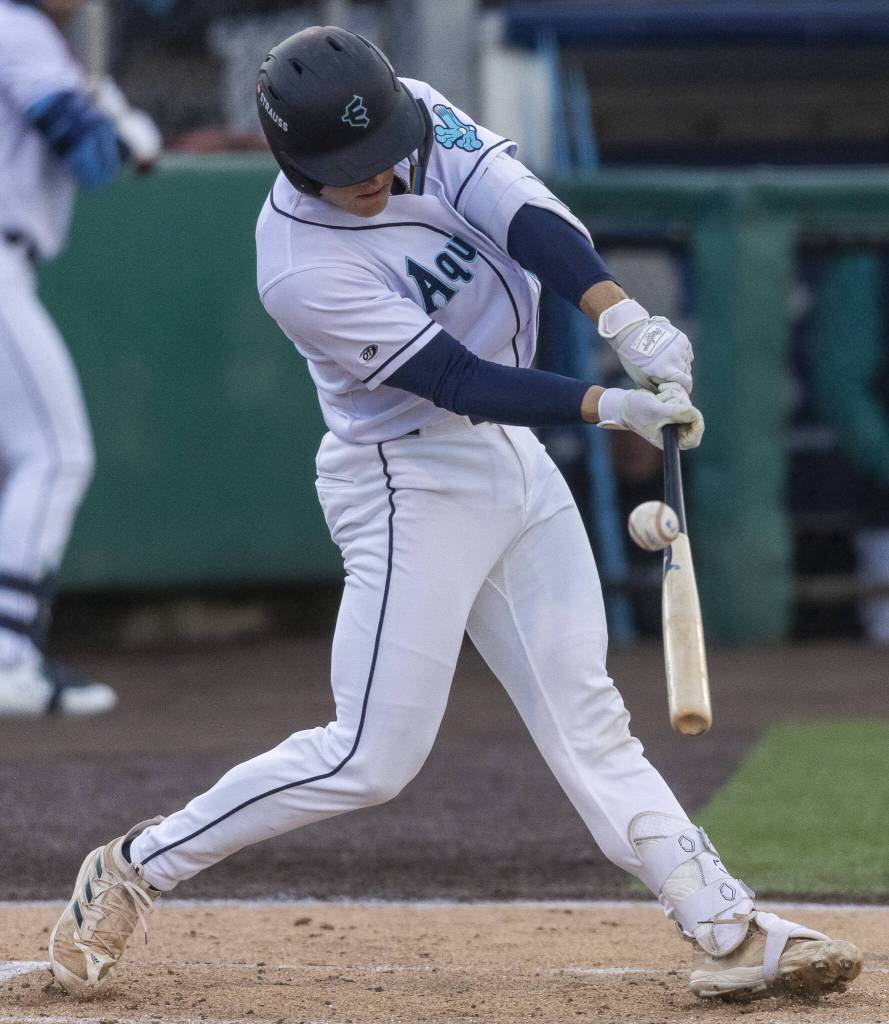 Everett AquaSox catcher Josh Caron hits a home run during the Opening Day game against the Hillsboro Hops on Tuesday, April 8, 2025 in Everett, Washington. (Olivia Vanni / The Herald)