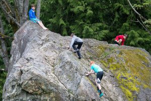 Kids play on glacial erratic in the Martha Lake Airport Park on Friday, May 4, 2018 in Lynnwood, Wa. The Glacial erratic rock in the park is one of the largest in urban King, Snohomish, and Pierce counties. (Andy Bronson / The Herald)
