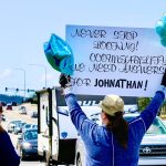 On the corner of Smokey Point Boulevard and 172nd St. NE, cars honk as protesters hold signs like Never stop looking and display blue balloons for Autism Awareness Month during a call to action Saturday, April 12, 2025, in Arlington, Washington. (Aspen Anderson / The Herald)