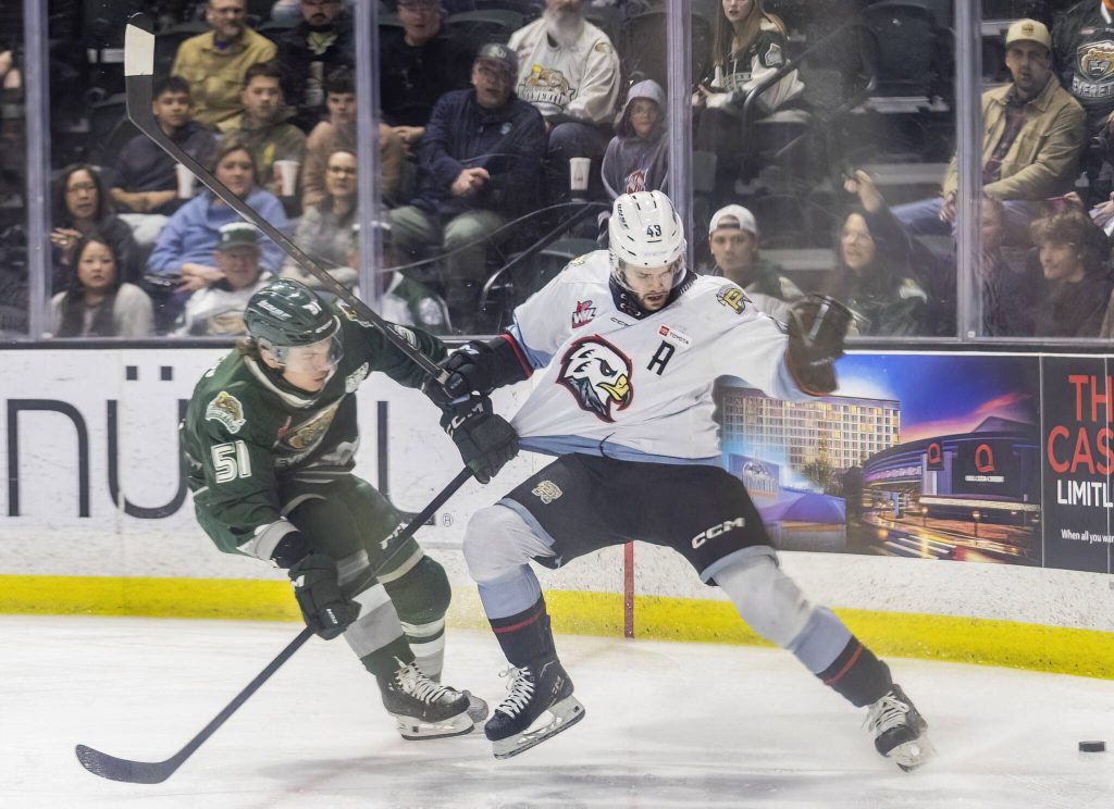 Everett Silvertips forward Jaxsin Vaughan grades the jersey of Portland Winterhawks Ryder Thompson during the second round WHL playoff game on Friday, April 11, 2025 in Everett, Washington. (Olivia Vanni / The Herald)