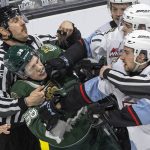 Multiple Portland Winterhawk players grab the jersey of Everett Silvertips forward Shea Busch during the second round WHL playoff game on Friday, April 11, 2025 in Everett, Washington. (Olivia Vanni / The Herald)