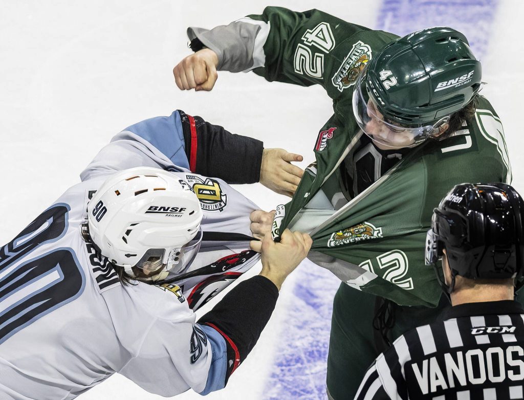 Everett Silvertips defenceman Brek Liske throws a punch at Portland Winterhawks Diego Buttazzoni during the second round WHL playoff game on Friday, April 11, 2025 in Everett, Washington. (Olivia Vanni / The Herald)