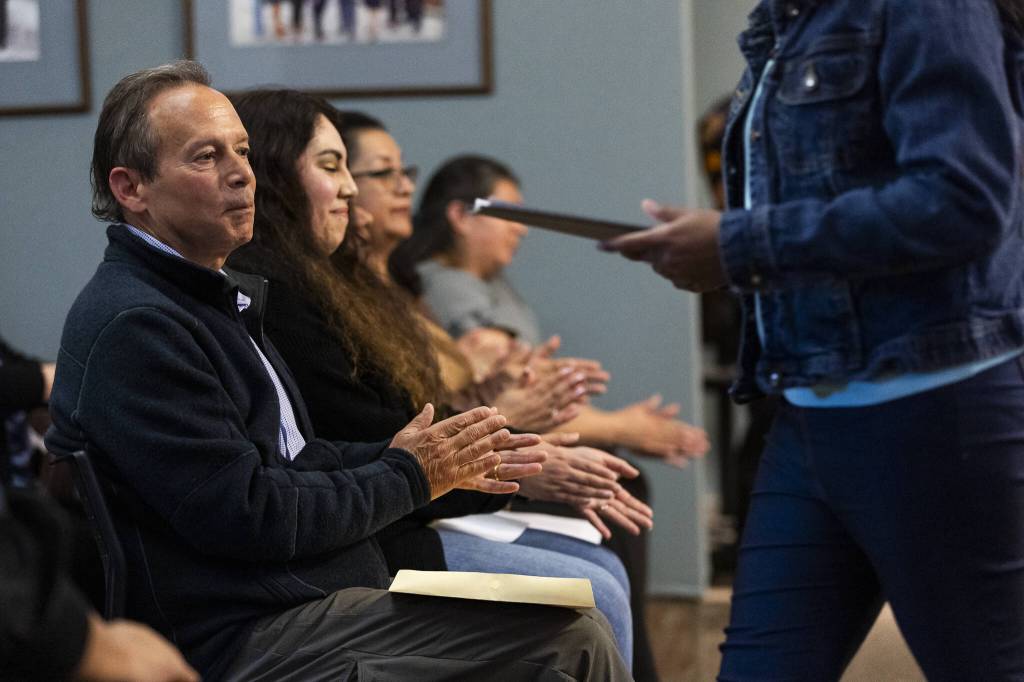 People clap as Casino Road residents share their thoughts and concerns to the Everett City Council on Wednesday, April 16, 2025 in Everett, Washington. (Olivia Vanni / The Herald)