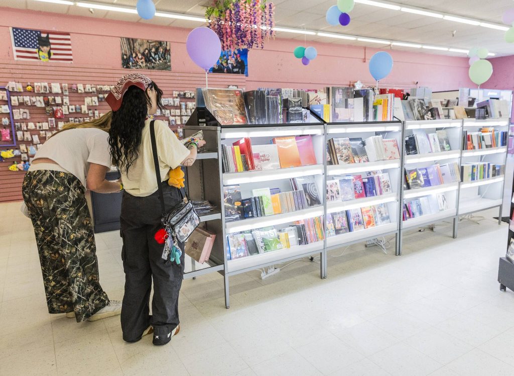 People browse the selection of albums at The K-POP Empire on Thursday, April 17, 2025, in Lynnwood, Washington. (Olivia Vanni / The Herald)