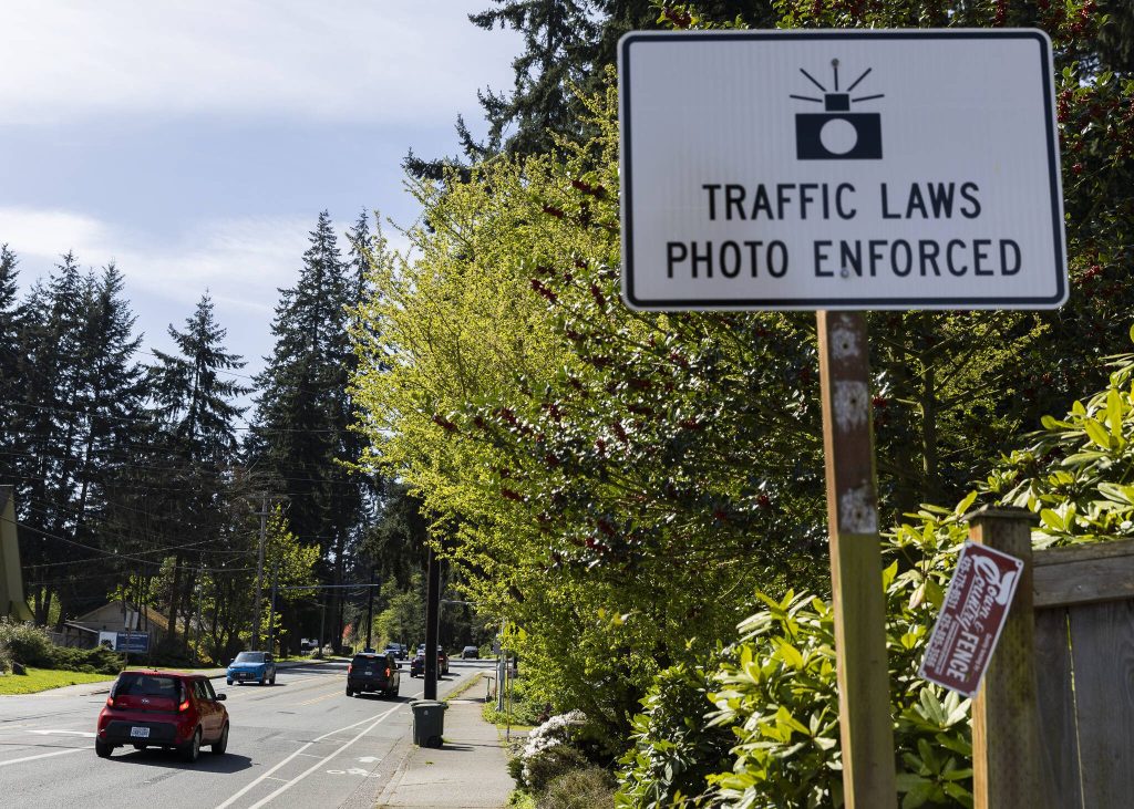 A sign alerts drivers to a traffic camera along 100th Avenue West on Monday, April 14, 2025 in Edmonds, Washington. (Olivia Vanni / The Herald)