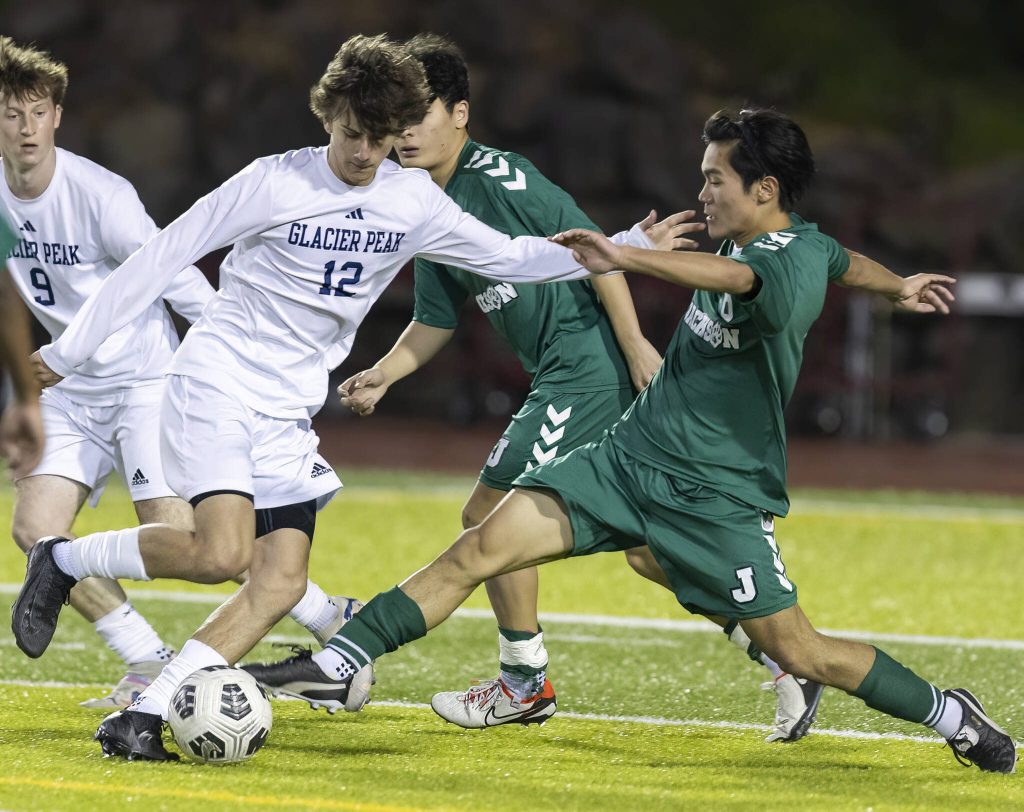 Jacksons Zigden Nhangkar reaches out to knock the ball away from the feet of Glacier Peaks Jonah Jacobs as he tries to take a shot during the game on Tuesday, April 15, 2025 in Everett, Washington. (Olivia Vanni / The Herald)