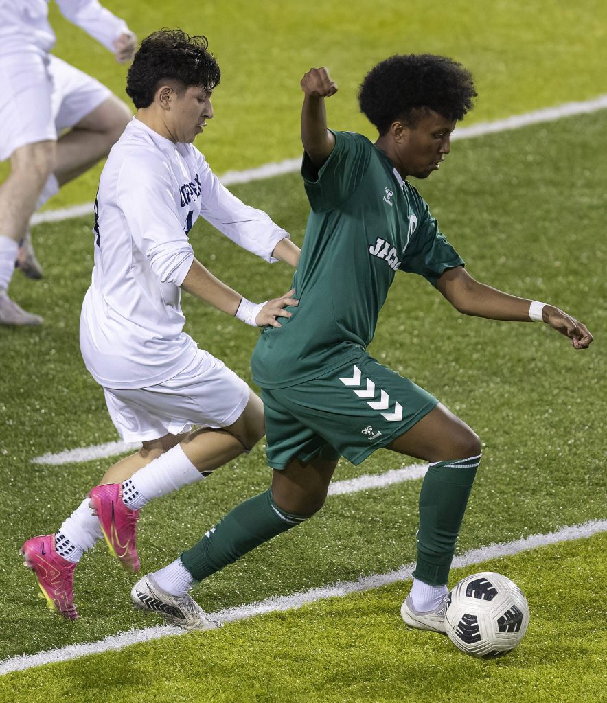 Jacksons Chris Abyot keeps the ball away from Glacier Peaks Ashton Resendiz during the game on Tuesday, April 15, 2025 in Everett, Washington. (Olivia Vanni / The Herald)