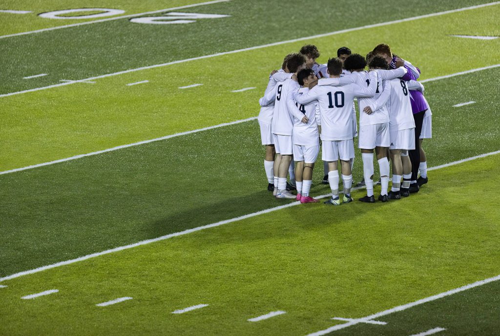 Glacier Peak players huddle on the field before the start of the second half during the game against Jackson on Tuesday, April 15, 2025 in Everett, Washington. (Olivia Vanni / The Herald)