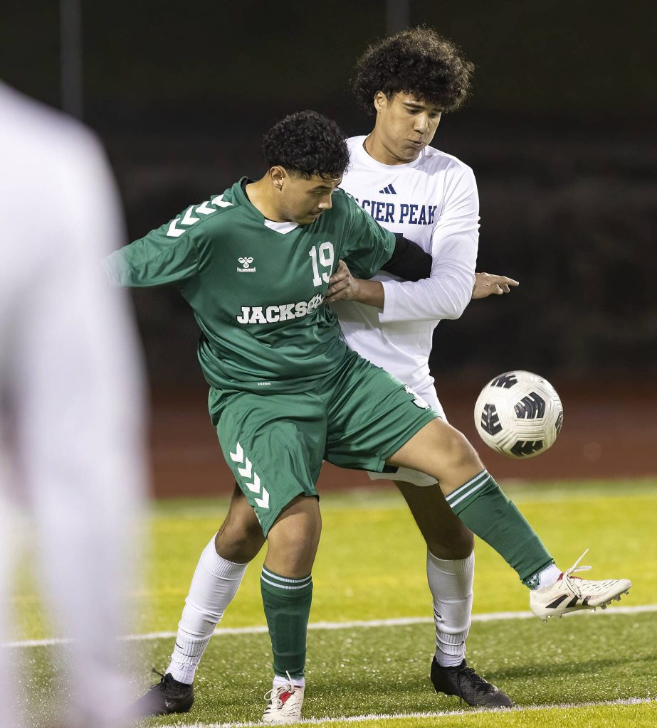 Jacksons Jorge Gomez-Morales traps the ball /while being guarded by Glacier Peaks Joziah Coppin during the game on Tuesday, April 15, 2025 in Everett, Washington. (Olivia Vanni / The Herald)