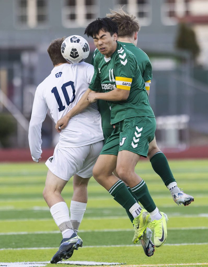 Jacksons Connor Huynh leaps up to head the ball during the game against Glacier Peak on Tuesday, April 15, 2025 in Everett, Washington. (Olivia Vanni / The Herald)