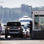 A Canada Border Services Agency officer speaks to a motorist entering Canada at the Douglas-Peace Arch border crossing, in Surrey, B.C., on Monday, August 9, 2021. THE CANADIAN PRESS/Darryl Dyck