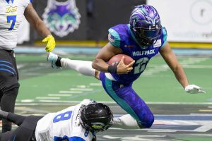 Washington Wolfpack's Ed Crouch Jr. leaps to try and escape a tackle by Nashville Kats' Derrick Maxwell Jr during the game on Thursday, April 17, 2025 in Everett, Washington. (Olivia Vanni / The Herald)