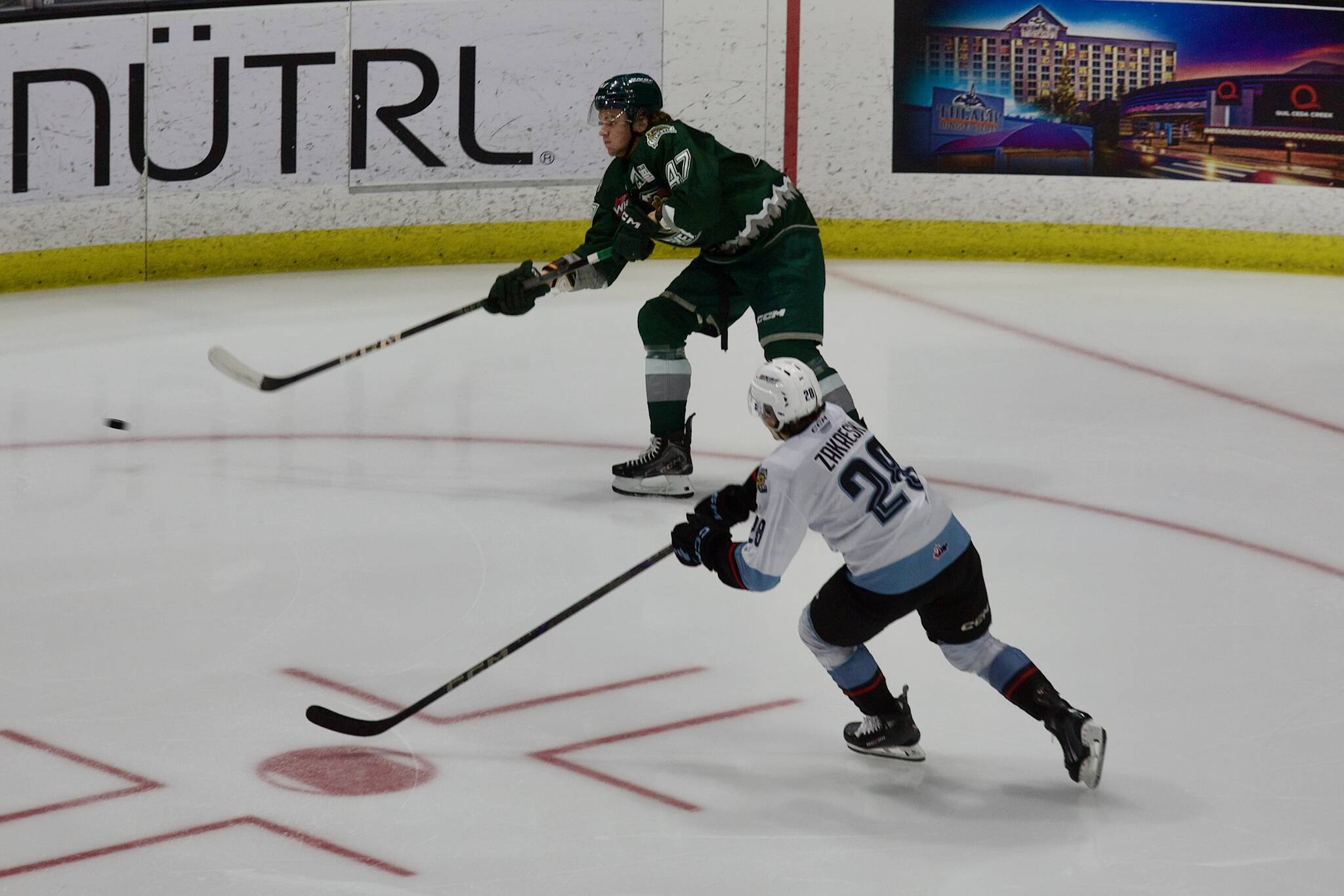 Silvertips defenseman Kaden Hammell passes the puck up ice as Winterhawks forward Josh Zakreski tries to forecheck during Everett's 4-3 loss in Game 5 of the WHL Western Conference Semifinals at Angel of the Winds Arena in Everett, Washington on April 18, 2025. (Joe Pohoryles / The Herald)