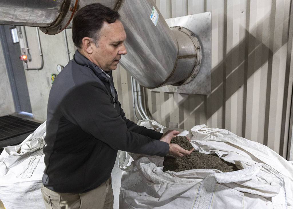 President and Chief Technology Officer of EcoRemedy David Mooney shows one of the byproducts from the gasification process on Thursday, April 17, 2025 in Edmonds, Washington. (Olivia Vanni / The Herald)