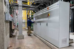An EcoRemedy employee checks a control panel of their equipment at the Edmonds Wastewater Treatment Plant on Thursday, April 17, 2025 in Edmonds, Washington. (Olivia Vanni / The Herald)