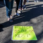 Over a dozen parents and some Snohomish School District students gather outside of the district office to protest and discuss safety concerns after an incident with a student at Machias Elementary School on Friday, April 18, 2025 in Snohomish, Washington. (Olivia Vanni / The Herald)