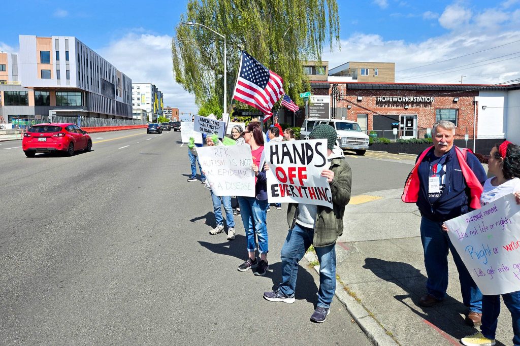 Protesters line the Broadway on Saturday afternoon in Everett. (Aaron Kennedy / The Herald)
