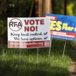 Signs in support of and opposition of the Proposition 1 annexation into RFA are visible along 100th Avenue West on Thursday, April 3, 2025 in Edmonds, Washington. (Olivia Vanni / The Herald)
